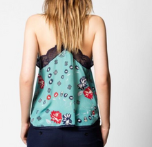 Load image into Gallery viewer, Person wearing a floral-patterned top with a lace trim on a plain background