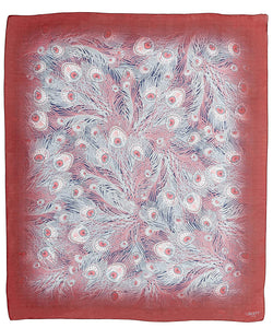 A red silk scarf with a white peacock feather pattern and blue accents, with finished edges and a signature logo in the corner.